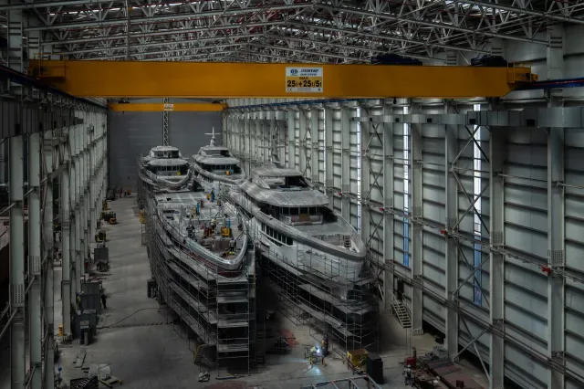 Hulls under construction inside a covered building hall